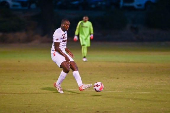 Soccer player passes the ball.